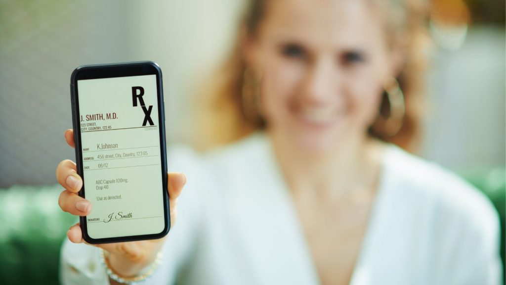 スマホ(電子処方箋)を持つ女性写真